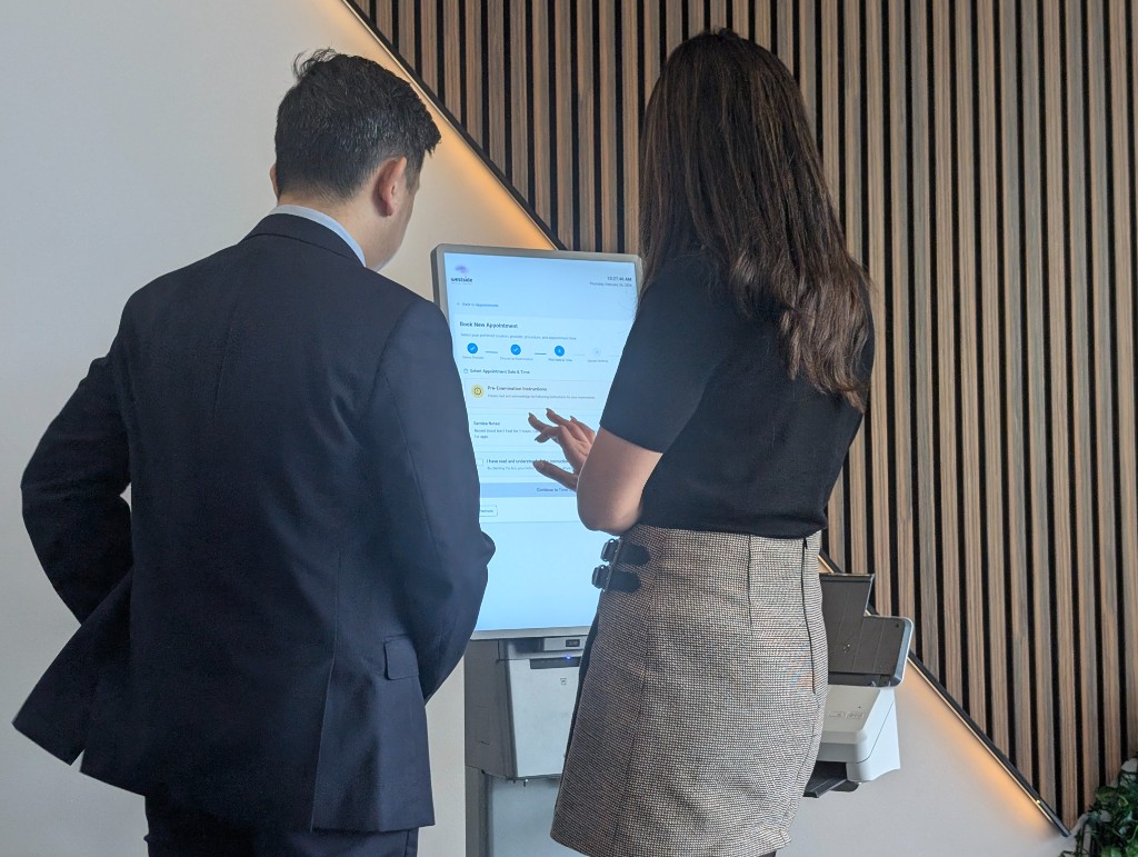 Photo of kiosk showing multi-step appointment booking with progress indicator