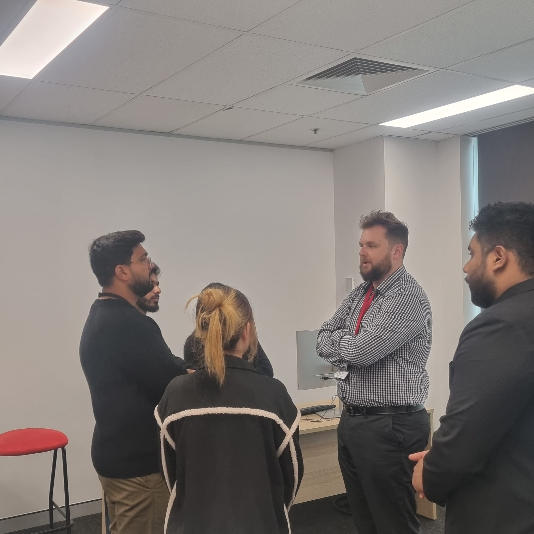 Trucell CEO Jason Mead in conversation with University of Tasmania Sydney campus students after the panel, discussing how to identify a personal area of specialisation early in a tech career