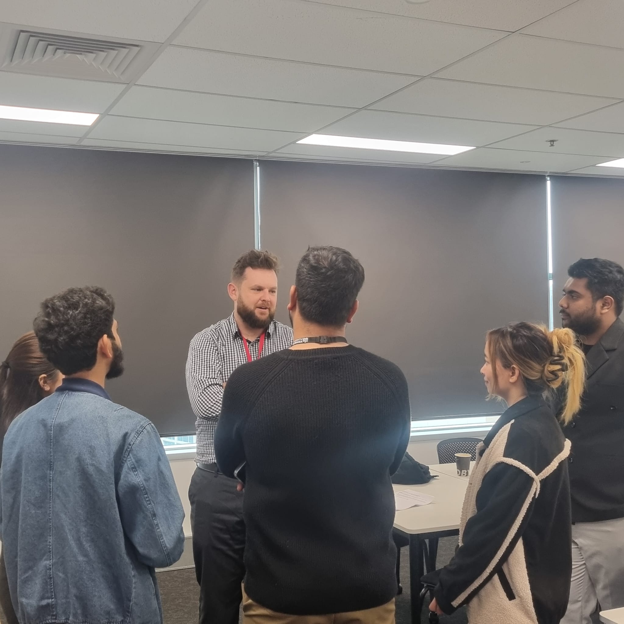Trucell CEO Jason Mead in a small-group discussion with University of Tasmania Sydney campus students after the fireside panel, fielding follow-up questions about industry expectations and early-career direction